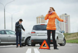 a woman and man on the phone after an accident