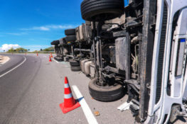 overturned truck on the side of the road