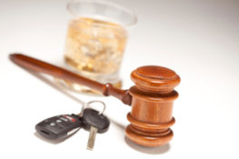 gavel, car key and alcohol