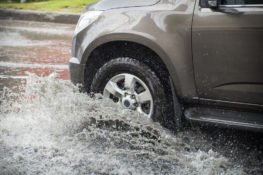 car driving over a water puddle