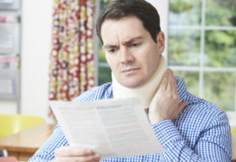 man reading legal documen after accident