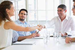 Man and a woman shaking hands in a mini trial