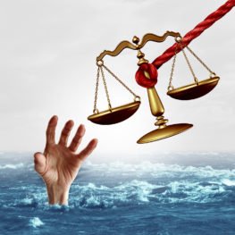 justice scale being offered to save a drowning person as a symbol of attorney services solving problems