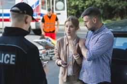 Couple filing a police report after a car crash