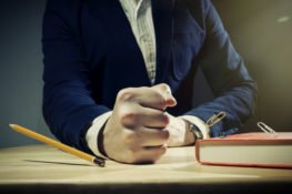 person slamming fist down on desk