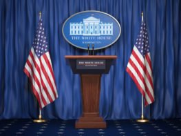 podium with american flags on each side