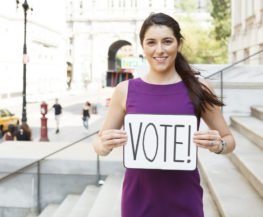 young female with vote sign