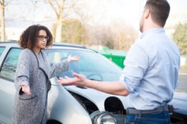 Man And Woman Arguing After Car Crash
