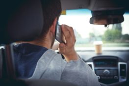 man making a phone call while driving