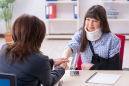 A woman talking to an attorney for a personal injury case