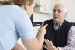 nursing home worker pointing finger at residents face