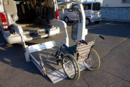 A wheelchair being loaded into a healthcare transportation
