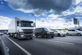 Semi trucks and cars traveling on highway