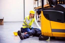 Woman calling for help after a man suffers an on the job injury in a San Antonio warehouse.