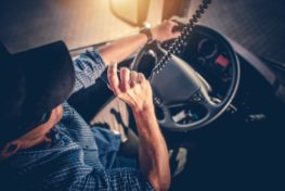 Semi Truck Driver Making Conversation with Other Truck Drivers Through CB Radio.