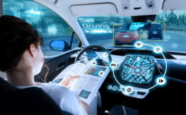 A woman reading while using automated automobile