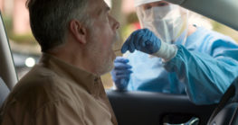 Man getting checked for coronavirus in his car