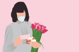 A Mother holding a card and flowers