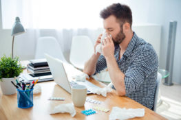 man in an office with coronavirus