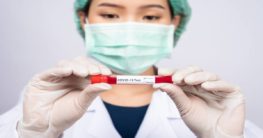a healthcare professional holding a covid-19 test