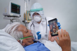 elder covid-19 patient talking with family remotely