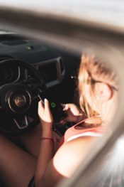 woman opening spotify before driving