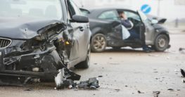 two broken black cars after accident