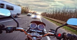 a motorcycle about to crash on a car