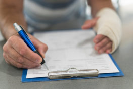 injured man filling personal injury claim form