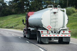  Large oil tanker truck hauling on highway