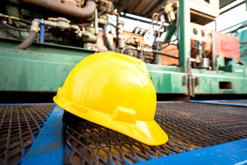 yellow hard hat on an oil field site